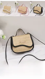 Detail view of woven straw handbags featuring wavy flap trim and metallic logo detail
