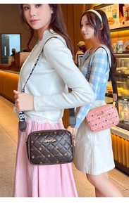 Detail of quilted crossbody bags with letter print wide straps and metal logo plate