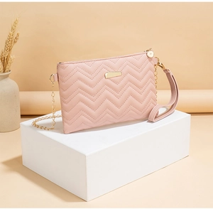 Pink quilted envelope bag with gold hardware and chain strap on a white pedestal