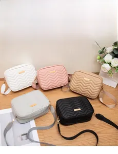 Flat lay of colorful quilted crossbody bags with adjustable straps in a studio setting