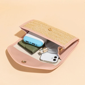 Pink and beige straw envelope bag showing internal storage for essentials like a phone
