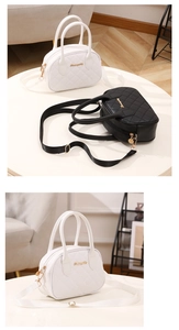 Detail of white and black quilted pillow bags with gold logo and adjustable straps