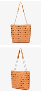 Detail of orange quilted tote bag with Luck For You print and gold chain strap