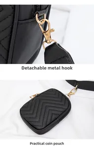 Detail of black chevron quilted handbag with detachable gold hooks and small coin purse
