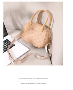 Quilted beige satchel bag with wide strap displayed on a sofa in a modern setting