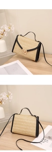 Detail of straw woven crossbody bag with gold metal clasp and black leather trim