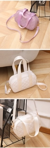 Detailed quilted texture of small Boston bags with golden hardware and adjustable straps