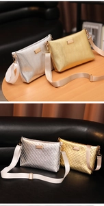 Detail of wave and lattice textures on gold and silver metallic envelope bags