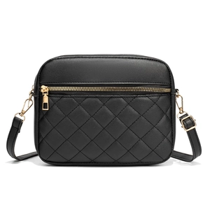 Minimalist black quilted camera bag with elegant gold zipper and adjustable shoulder strap