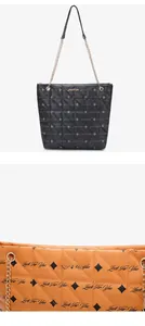 Close-up of quilted tote bag featuring chain strap and Luck For You logo details