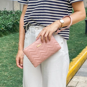 Pink quilted clutch bag with wave stitching and gold geometric metal hardware decoration