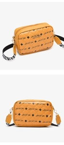Close-up of yellow quilted crossbody bag with Luck For You logo and woven strap