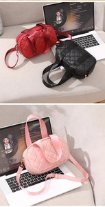 Close-up of quilted Boston crossbody bags in red, black, and pink with woven straps
