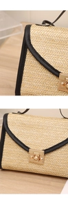Detail of natural straw weave texture and black leather trim with gold metal clasp