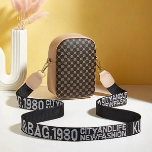 Vertical monogram crossbody phone bag with wide letter-print strap on colorful background