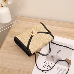 Straw woven square crossbody bag with black leather trim and golden metal lock