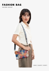 Colorful geometric patchwork shoulder bag with wide branded strap shown on a model