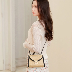 Minimalist straw crossbody bag with black leather trim and golden metal lock buckle
