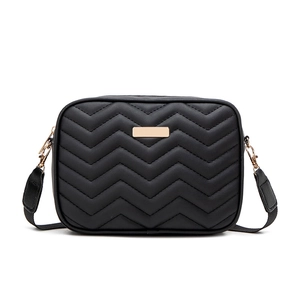 Black quilted crossbody camera bag with wave stitching and gold hardware on white background