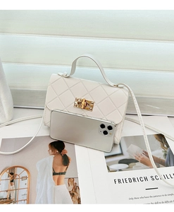 Mini white quilted crossbody bag with gold lock compared to a smartphone size