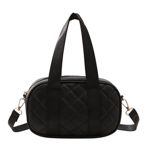 Classic black quilted Boston handbag with gold hardware and shoulder strap on white background