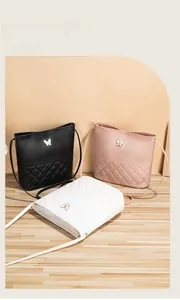 Variety of quilted bucket bags in black, pink and white with golden butterfly buckles
