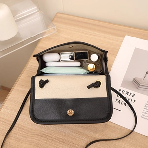 Minimalist bicolor mini woven crossbody bag for women showing inner storage capacity