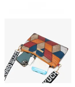 Detail view of colorful geometric crossbody bag showing interior space for smartphone and power bank