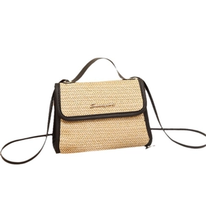 Women's woven crossbody bag in beige straw with black trim and elegant hand straps