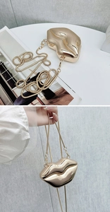 Close-up of golden lip-shaped acrylic evening clutch with metallic chain and mirror finish