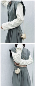 Close-up of golden star-shaped and shell-shaped mini acrylic handbags with metal chains