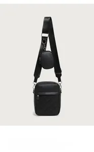 Detailed view of black vertical quilted crossbody bag with detachable round coin purse