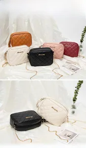 Quilted camera bag details showing S-logo, metallic chain strap and fringe tassel zipper