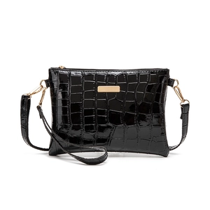 Minimalist black faux crocodile leather shoulder bag with gold hardware and zipper detail