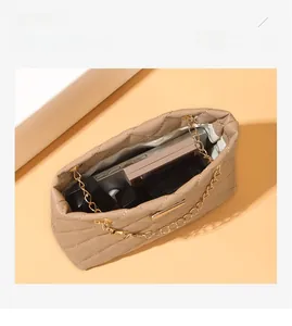 Detailed top view of a quilted crossbody bag showing its large interior storage capacity