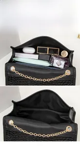 Detail showing the large storage capacity of a black crocodile pattern chain handbag