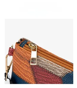 Detail of color-block textured leather bag with premium gold zipper and lizard skin pattern