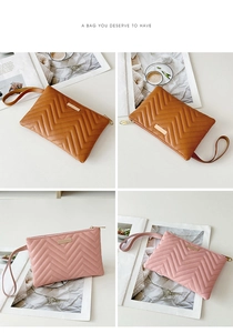 Detail of chevron quilted wristlet bag with zipper and metal plaque in brown and pink