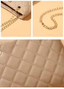 Detailed view of khaki quilted bucket bag featuring gold chain strap and PU leather texture