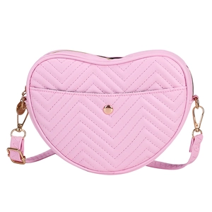 Pink heart-shaped crossbody bag with chevron quilting and gold metal hardware detailing