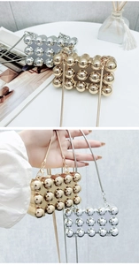 Detail of mini acrylic star shell bag with metal spheres and chic snake chain strap