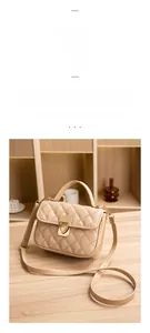 Close-up of diamond-quilted beige leather handbag with gold twist-lock and shoulder strap