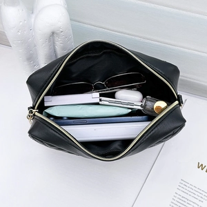 Quilted wave pattern crossbody bag with golden zipper showing spacious interior storage