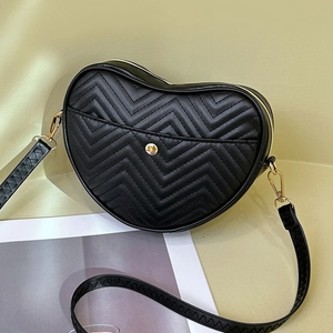 Chic black heart-shaped crossbody bag with chevron quilting and golden zipper detail