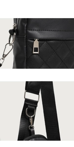 Close-up of black quilted leather texture and silver metal hardware on a crossbody bag