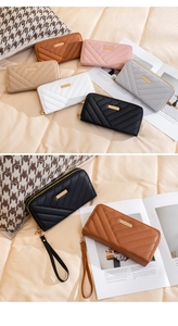 Detail of multi-color V-quilted faux leather long wallets with gold hardware and wristlets