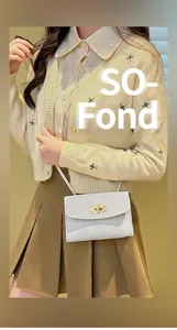 Close-up of white quilted crossbody bag with gold turn-lock and elegant metal chain strap