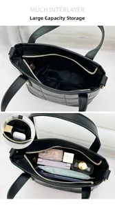Detail showing multiple layers and inner storage space of black quilted tote bag