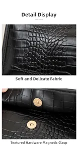 Close-up of black crocodile embossed leather handbag with gold magnetic clasp hardware