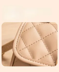 Close-up of diamond quilted stitching and texture on khaki faux leather handbag